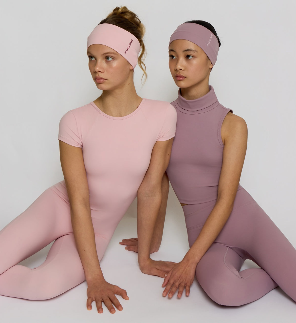 Two girls in pink and mauve matching activewear sets